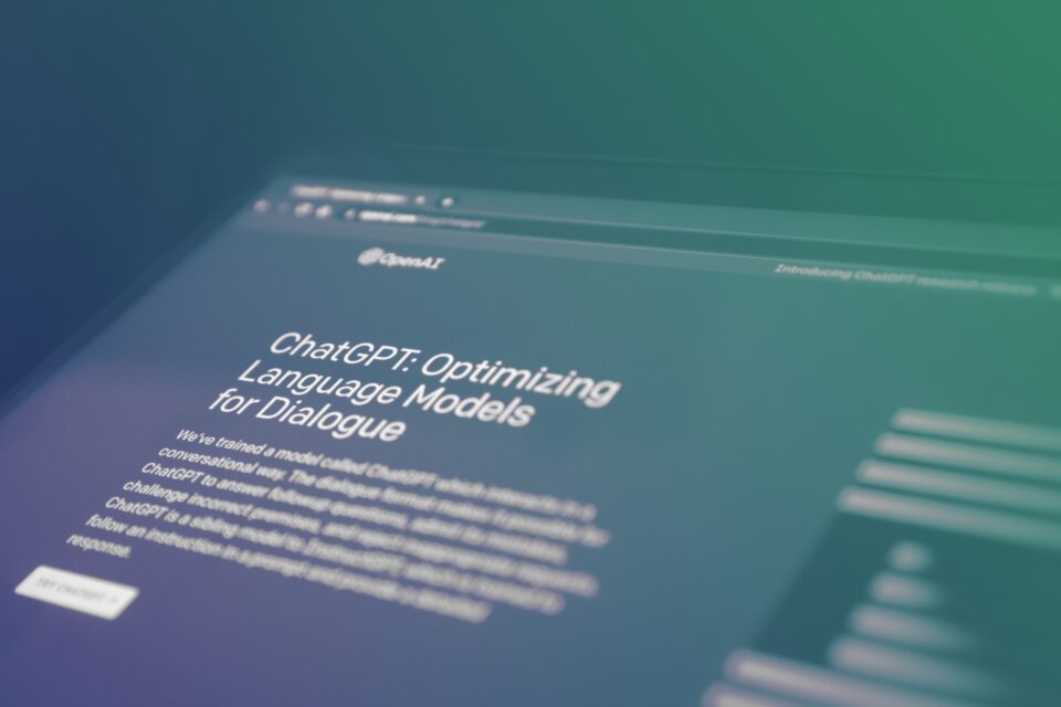 Image of a screen showing the OpenAI website and an article excerpt about ChatGPT.