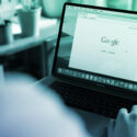 Photo of a laptop screen with an open Google search window.