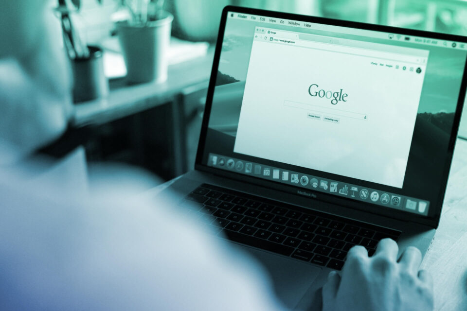 Photo of a laptop screen with an open Google search window.