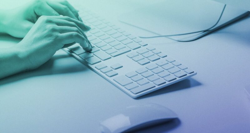 Photo of hands typing at a keyboard used as the feature image for an article titled 'Websites, word counts, and SEO—how many words do you actually need to rank well?'.